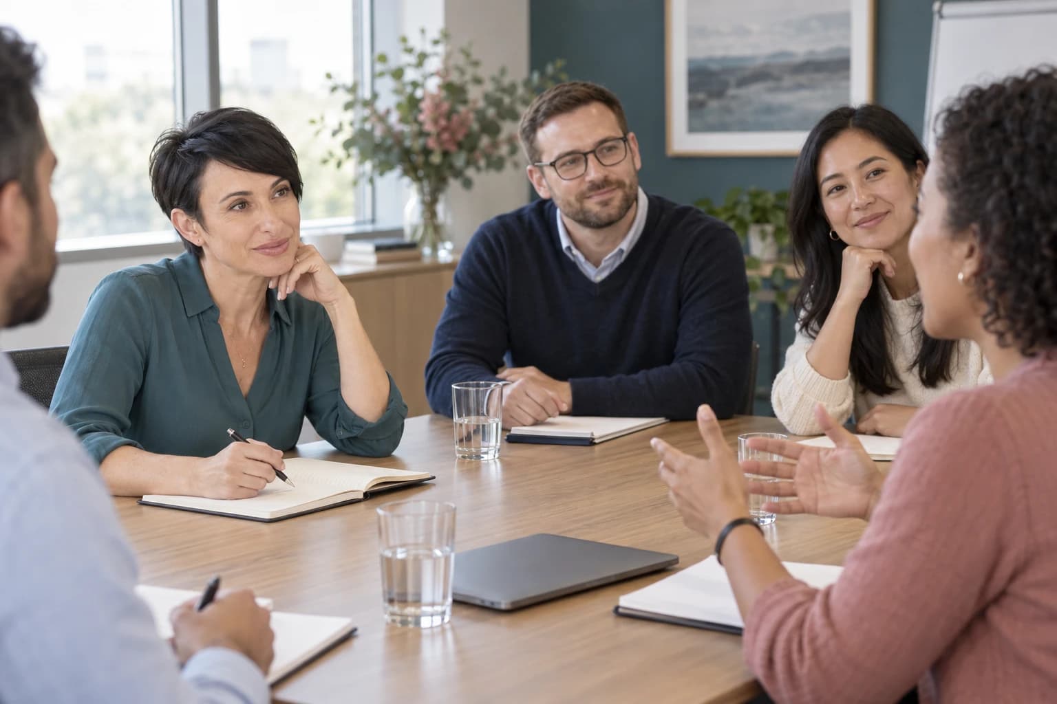 Tamara Keller listening during a small-group workplace training discussion.